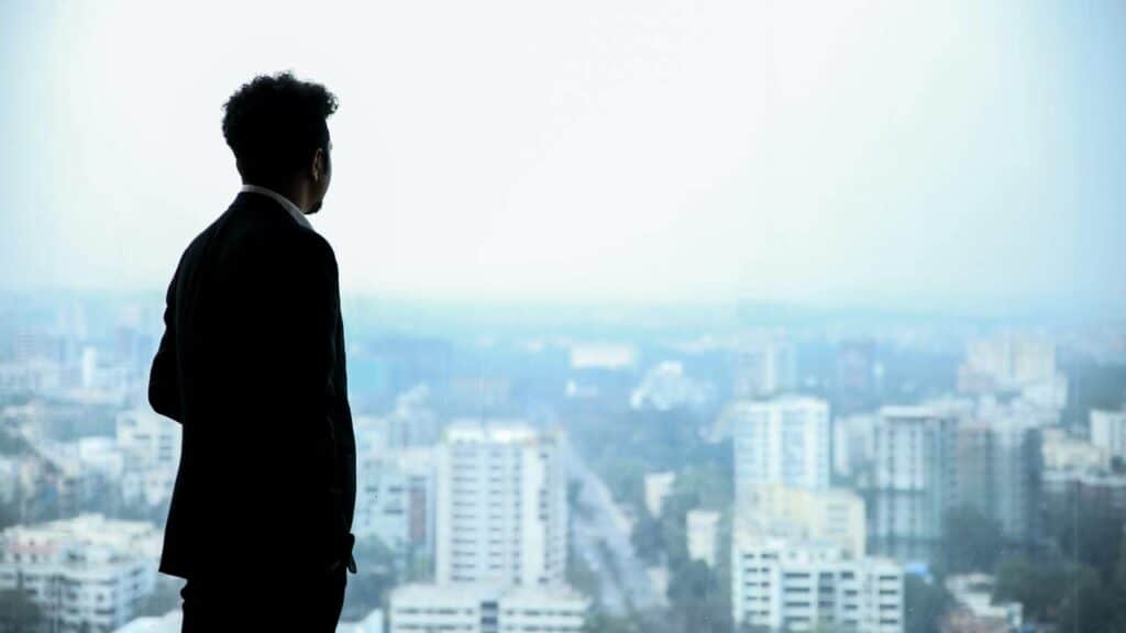 Businessman looking at the city through the window