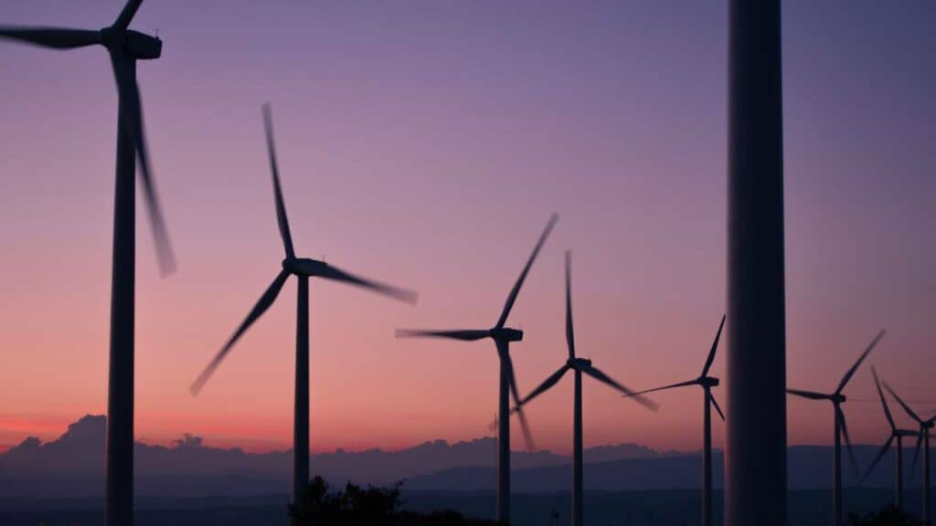 A view of many modern windmills at sunset